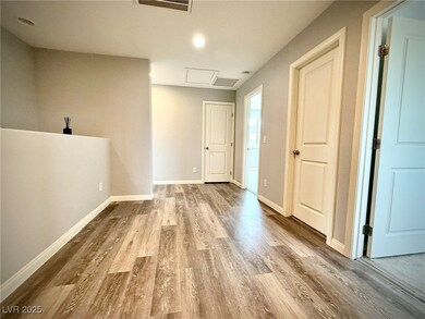 Empty room with visible vents, baseboards, and woo