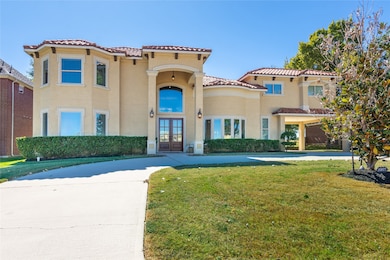 A closer look at the stunning front elevation highlights the architectural details, tall windows, and impeccable exterior design. The manicured landscaping frames the entry perfectly for a warm, welcoming first impression.