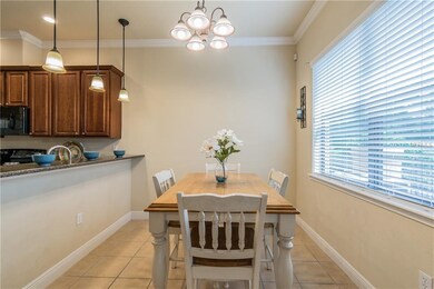 Dining room off of the kitchen with crown molding