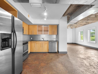 Kitchen featuring stainless steel appliances, open