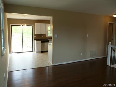 View from Living Room into Eat-In Kitchen - Dining area - new chandelier - sliding glass door leading to deck