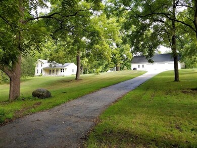 Driveway view of Home and Garage