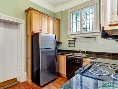 Kitchen with hardwood floor and fully equipped wit
