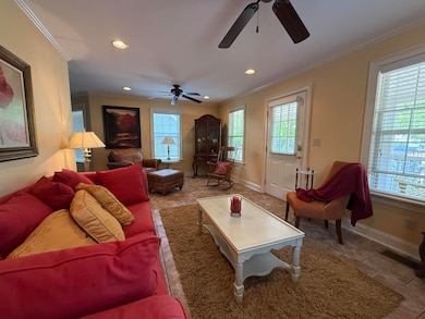 Living area with ornamental molding, recessed ligh