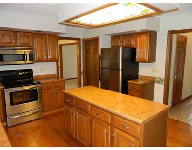 Kitchen. Kitchen features hardwood floors and stai