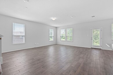 Spare room with dark wood finished floors and bas
