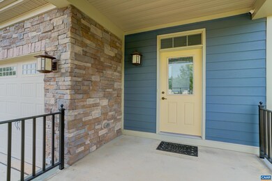 Covered front porch leads to welcoming front door 