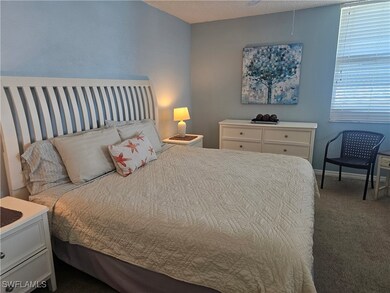Carpeted bedroom featuring impact windows with vie