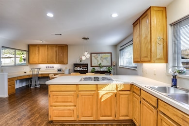Designed with both beauty and function in mind, the kitchen showcases rich wood cabinetry with custom pull-outs—making time spent cooking truly enjoyable.
