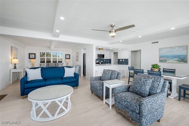 Living area featuring beam ceiling, light wood-sty