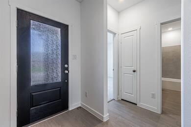Foyer featuring baseboards and light wood-style flooring