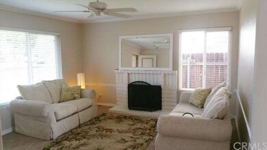 Brightly lite living room features gas fireplace, 