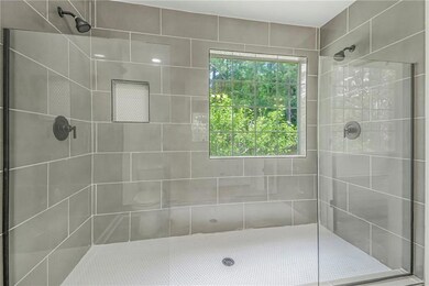 Full bathroom with tiled shower