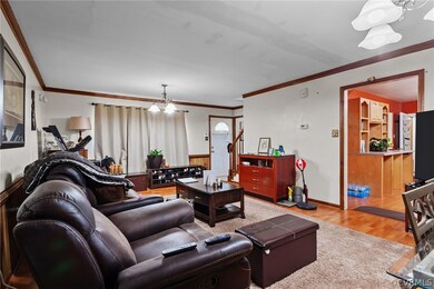 Living room with an inviting chandelier, crown mol
