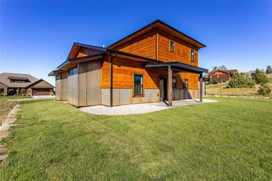 Back of house featuring a lawn and a patio