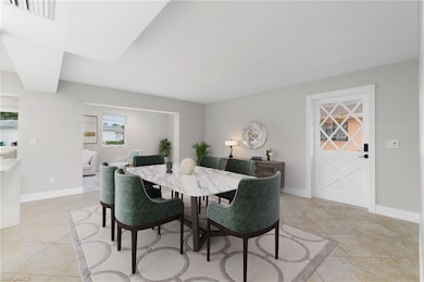 Dining space featuring light tile patterned floors