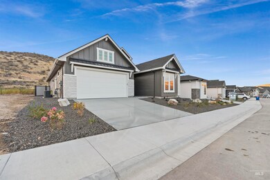 Craftsman-style home with board and batten siding, concrete driveway, a garage, a standing seam roof, and a metal roof