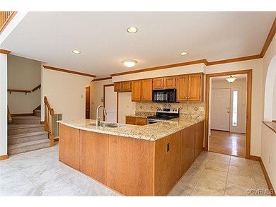 Kitchen is open to family room and has newer tile 