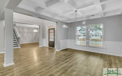 Dining room with coffered ceilings & upgraded ligh