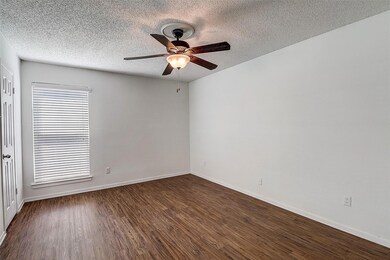 Empty room featuring ceiling fan, dark hardwood / 