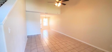 Spare room featuring a ceiling fan and light tile