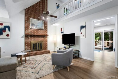 Living room featuring ceiling fan, a fireplace, da