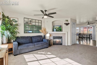 Living room featuring a fireplace, carpet floors, 