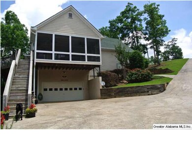 SIDE OF HOME SHOWING SCREENED PORCH AND GARAGE