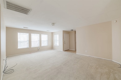 View toward front entry and staircase—ideal for open-concept living or entertaining.