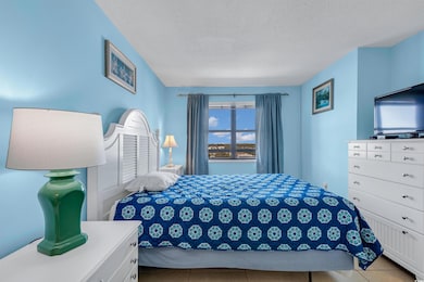 Tiled bedroom featuring a textured ceiling
