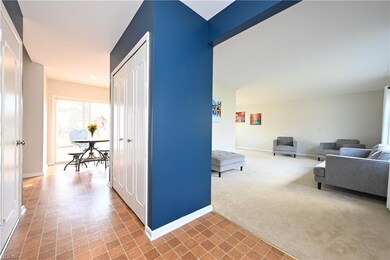 Bright and freshly painted entry with large coat c