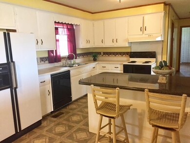 Kitchen has bar for extra seating and storage, stove, refrigerator, Dishwasher