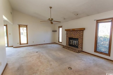Unfurnished living room featuring a ceiling fan, a