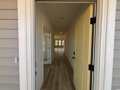 Hallway with recessed lighting, LVP flooring, and baseboards