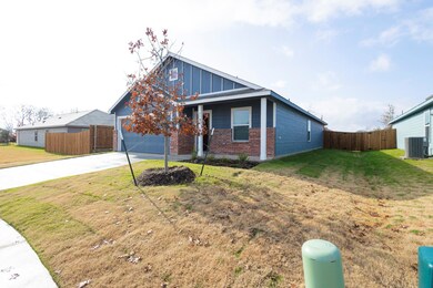 View of front of home with a front yard, a garage,