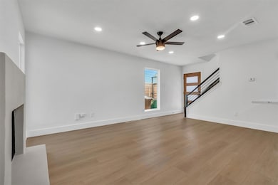 Unfurnished living room with a ceiling fan, reces