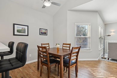 Dining room with lofted ceiling, a ceiling fan, ba