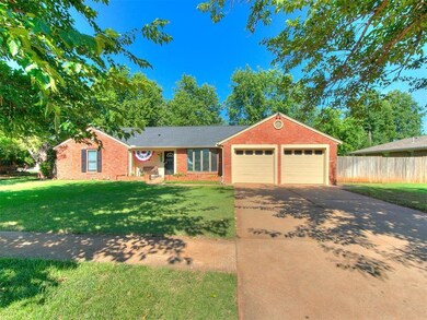 Ranch-style home featuring a garage and a front ya