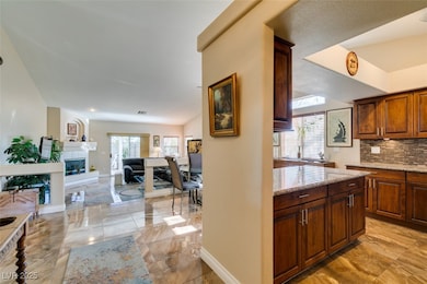 Kitchen featuring light marble finish floors, tast