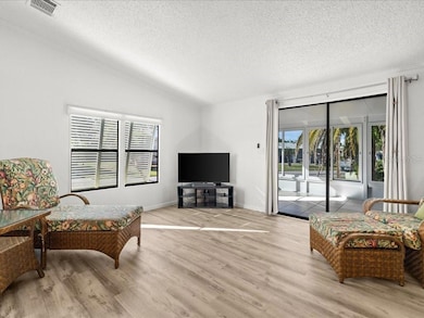 STEPPING INSIDE YOU WILL FIND A SPACIOUS LIVING AREA WITH SLIDING DOORS LEADING TO ANOTHER UPDATED LANAI WITH WINDOWS AND SCREENS.