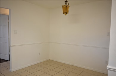 Dining room featuring tile patterned floors and baseboards