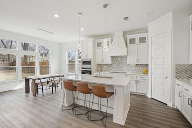 Kitchen featuring custom exhaust hood, white cabin