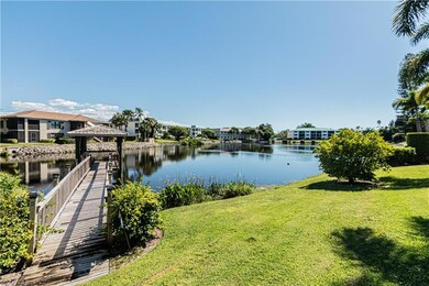 Dock featuring a gazebo, a water view, and a lawn