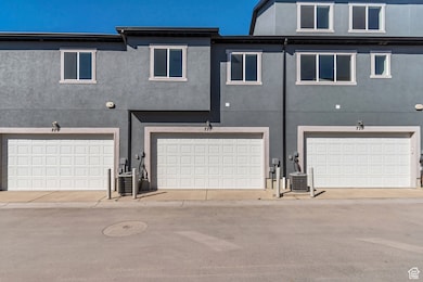 Back of property featuring stucco siding and a garage