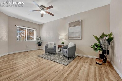 Sitting room with a ceiling fan, baseboards, and w