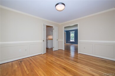 Dining Room with hardwood floors, crown and chair
