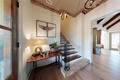 A generous foyer features a wood beam as a first s