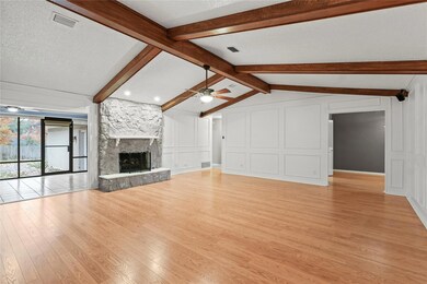 Unfurnished living room with lofted ceiling with b