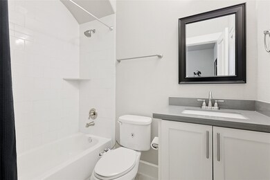 Adjoining full bathroom with modern finishes provides comfort and convenience for guests or everyday use.