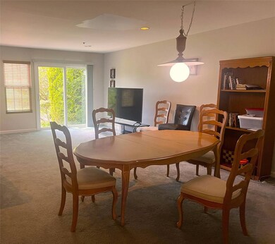 Carpeted dining room with an office area and baseb